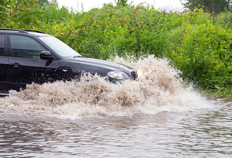 Car driving through flood in need of Flood Insurance in Quincy, MA, Hingham, Braintree, Weymouth, Belmont & Surrounding Areas 