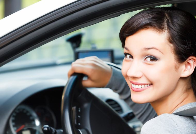 Car Insurance in Quincy MA, Young Woman Smiling and Driving a Car