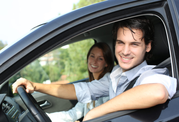 Two People in a Car With auto Insurance in Laconia, Weymouth, Alton, NH, Abington, MA, Hingham, and Surrounding Areas