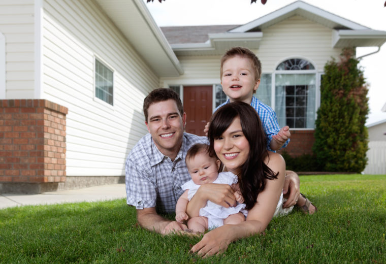 Family infront of their new house with good Life insurance in Holbrook