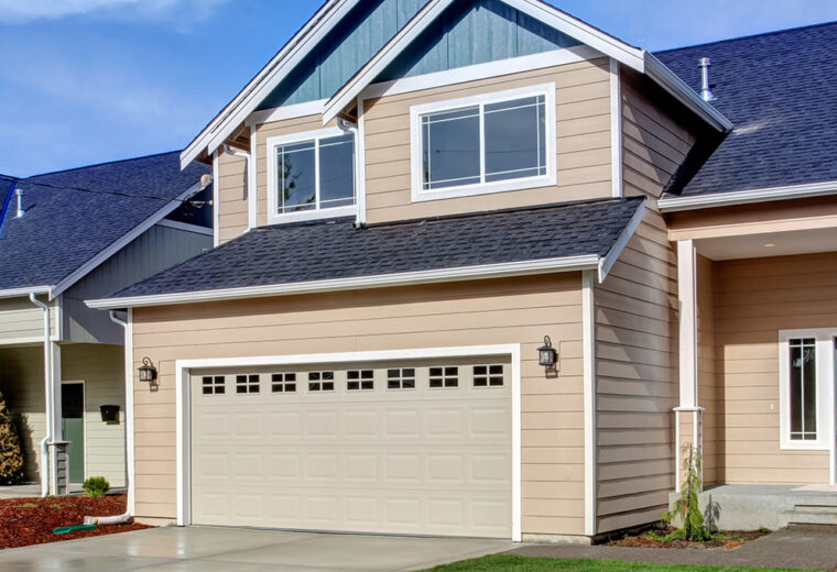 a peach colored house with a blue roof insured with Homeowners Insurance in Braintree